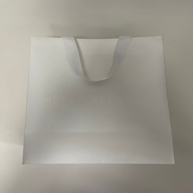 Packaging bag with ribbon handles